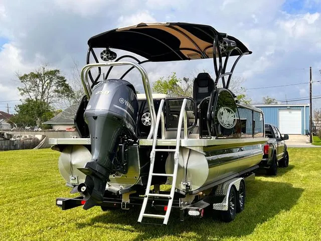 Slide: The Image of 2025 Aloha 23' Paradise Arch Sport Tower boat with Yamaha outboard motor on grass. - 13