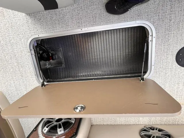 Slide: The Image of Open storage compartment in 2025 Aloha 23' Paradise Arch Sport Tower boat. - 14