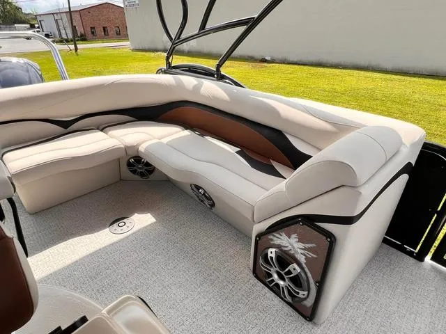 Slide: The Image of 2025 Aloha 23' Paradise Arch Sport Tower boat interior with plush seating and built-in speakers. - 4
