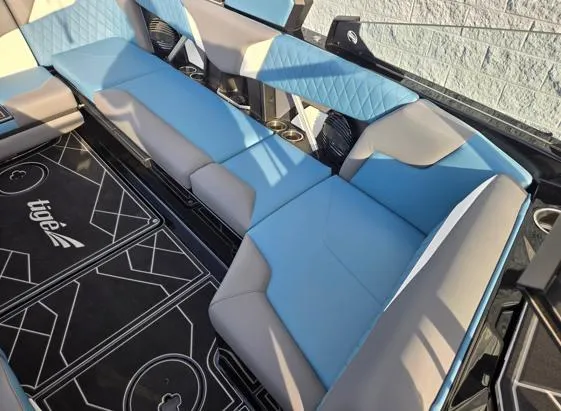 Slide: The Image of 2025 Tigé Z3 boat interior with blue and gray seating, showcasing modern design. - 11