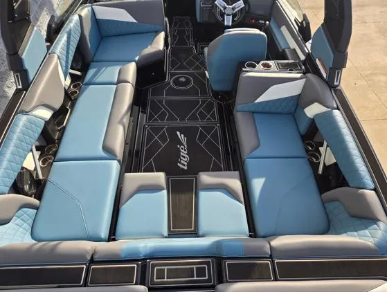 Slide: The Image of 2025 Tigé Z3 boat interior with luxurious blue seating and modern design. - 12