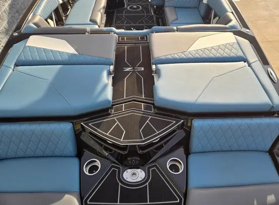 Slide: The Image of 2025 Tigé Z3 boat interior with blue seating and modern design. - 14