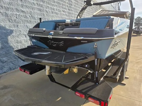 Slide: The Image of 2025 Tigé Z3 boat on trailer, blue and black design, parked outdoors. - 15