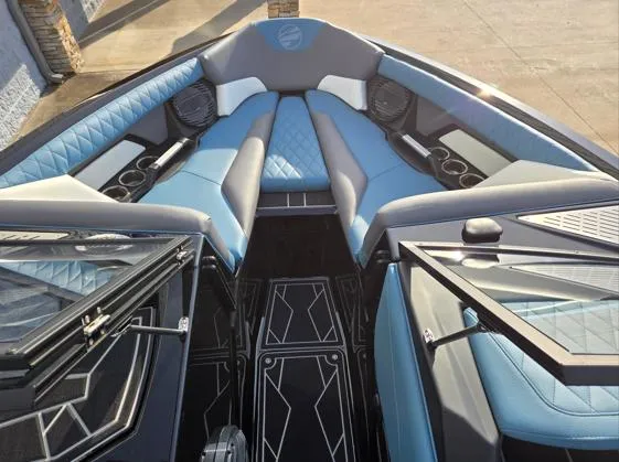 Slide: The Image of 2025 Tigé Z3 boat interior with blue and gray seating, cup holders, and speakers. - 3