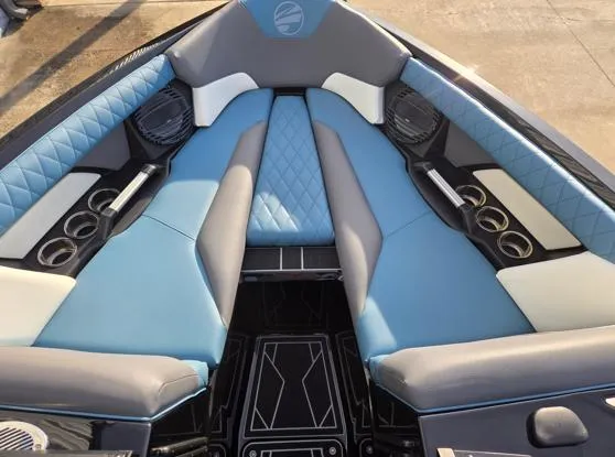 Slide: The Image of 2025 Tigé Z3 boat interior with blue and gray seating, cup holders, and speakers. - 4