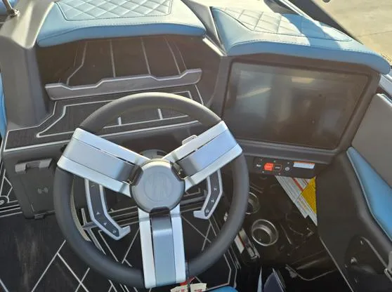 Slide: The Image of 2025 Tigé Z3 boat dashboard with modern steering wheel and touchscreen display. - 7