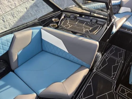 Slide: The Image of 2025 Tigé Z3 boat interior with blue and gray seating, modern design, and cup holders. - 8
