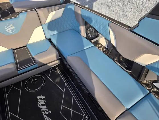 Slide: The Image of 2025 Tigé Z3 boat interior with blue and gray seating, cup holders, and stylish design. - 9