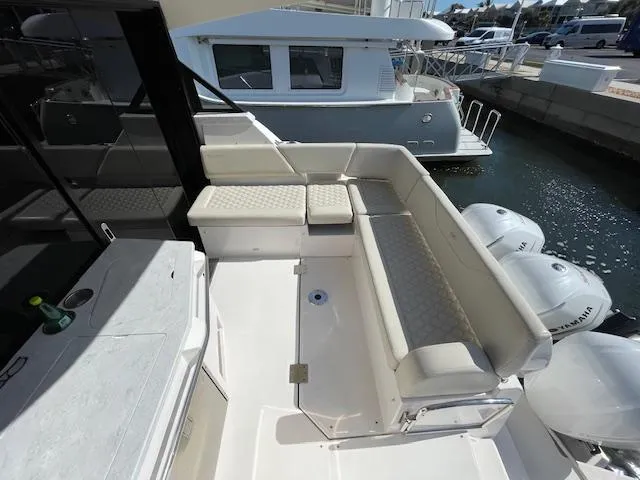 Slide: The Image of 2021 Regal 38 XO yacht with spacious seating and Yamaha outboard engines. - 14