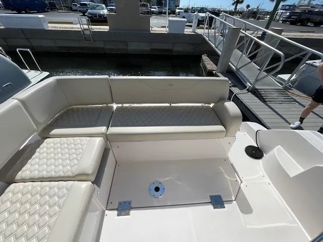 Slide: The Image of Luxury seating area on a 2021 Regal 38 XO boat docked at a marina. - 15