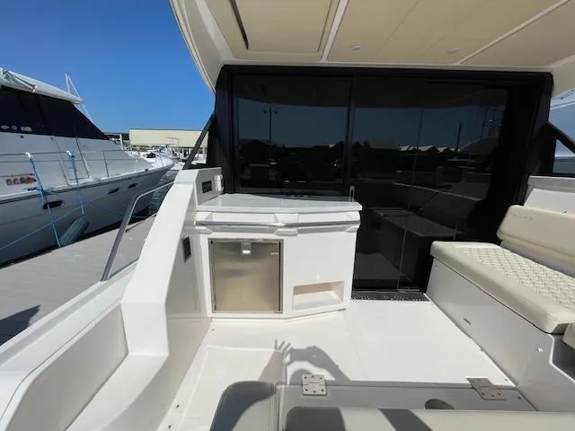 Slide: The Image of 2021 Regal 38 XO yacht deck with seating and storage area. - 18