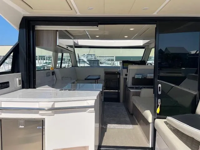 Slide: The Image of 2021 Regal 38 XO yacht interior with modern design and spacious seating area. - 22