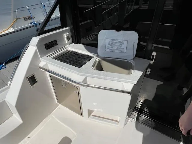 Slide: The Image of Outdoor kitchenette on 2021 Regal 38 XO yacht with grill and sink. - 24