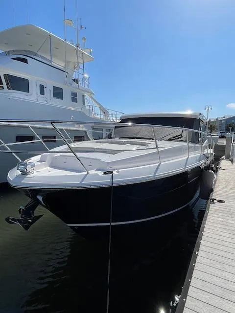 Slide: The Image of 2021 Regal 38 XO yacht docked at marina under clear blue sky. - 3