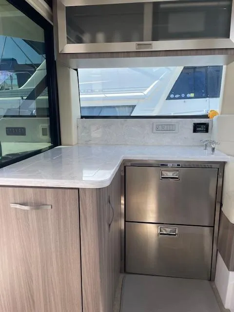 Slide: The Image of Modern kitchen area in 2021 Regal 38 XO yacht with sleek cabinetry and appliances. - 31