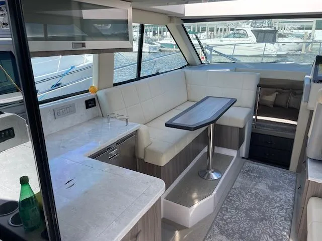 Slide: The Image of 2021 Regal 38 XO yacht interior with modern seating and dining area. - 33