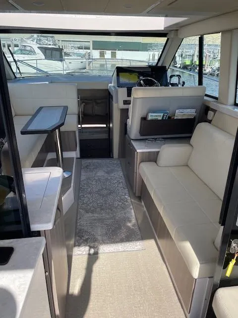 Slide: The Image of Interior of 2021 Regal 38 XO yacht with modern seating and navigation area. - 34