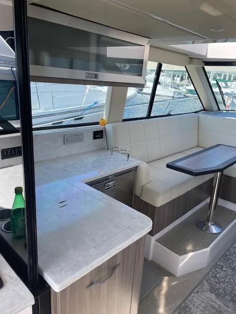 Slide: The Image of Interior of 2021 Regal 38 XO yacht with modern seating and sleek countertops. - 35