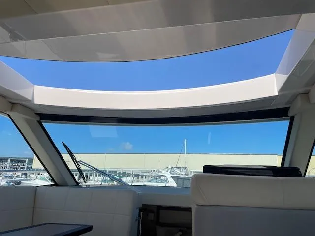 Slide: The Image of Interior view of 2021 Regal 38 XO yacht with panoramic windows and blue sky. - 37