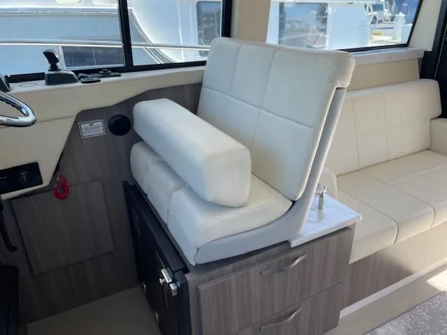 Slide: The Image of Interior of a 2021 Regal 38 XO yacht with white seating and wood accents. - 40