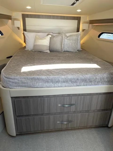 Slide: The Image of Luxurious bedroom interior of 2021 Regal 38 XO yacht with modern design and cozy bedding. - 44