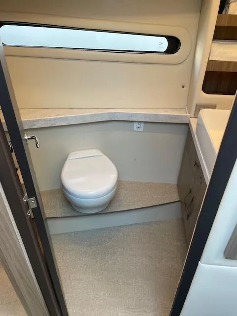 Slide: The Image of 2021 Regal 38 XO yacht bathroom with modern toilet and sleek design. - 48