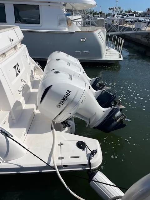 Slide: The Image of 2021 Regal 38 XO boat with Yamaha outboard engines docked at marina. - 6