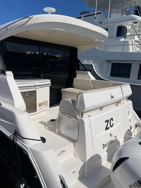 Slide: The Image of 2021 Regal 38 XO yacht, rear view, docked in marina. - 7