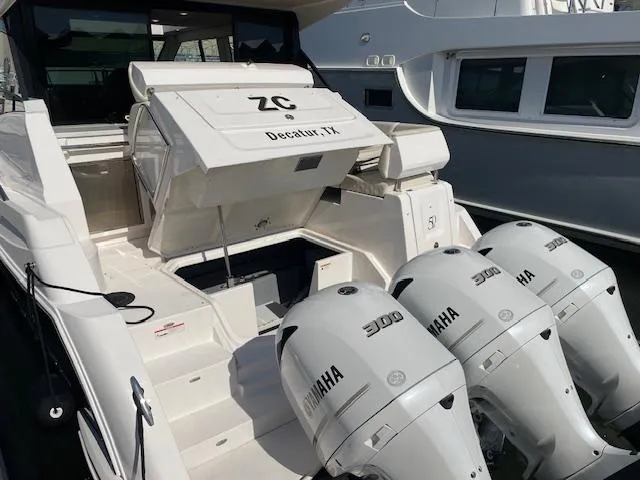 Slide: The Image of 2021 Regal 38 XO boat with triple Yamaha 300 engines docked at marina. - 9