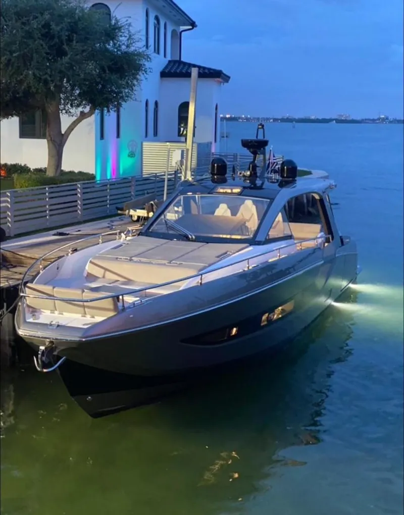 Slide: The Image of 2021 Azimut Verve 47 yacht docked by a waterfront house at dusk. - 10