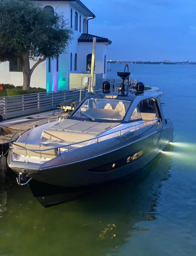 Slide: The Image of Azimut Verve 47 yacht, 2021 model, docked by a waterfront house at dusk. - 13