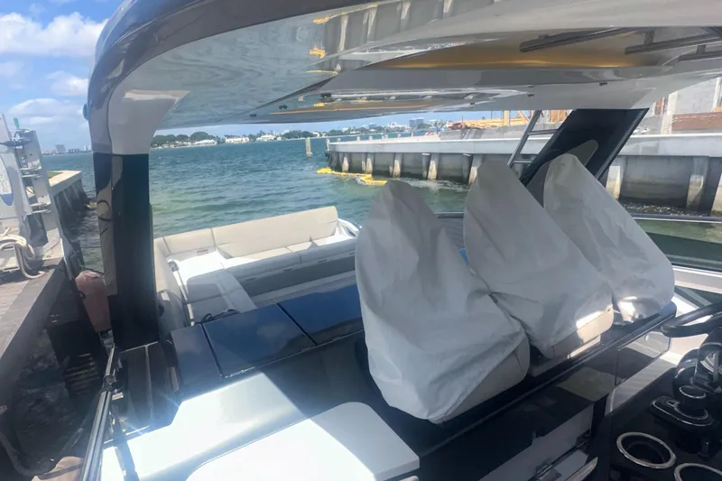 Slide: The Image of 2021 Azimut Verve 47 yacht interior with covered seating, docked by the water. - 23