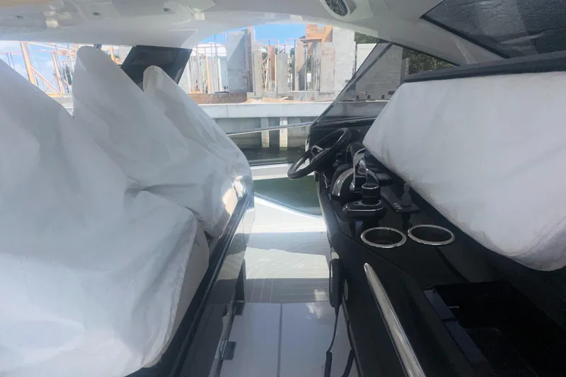 Slide: The Image of 2021 Azimut Verve 47 yacht interior with covered seats and modern dashboard. - 24