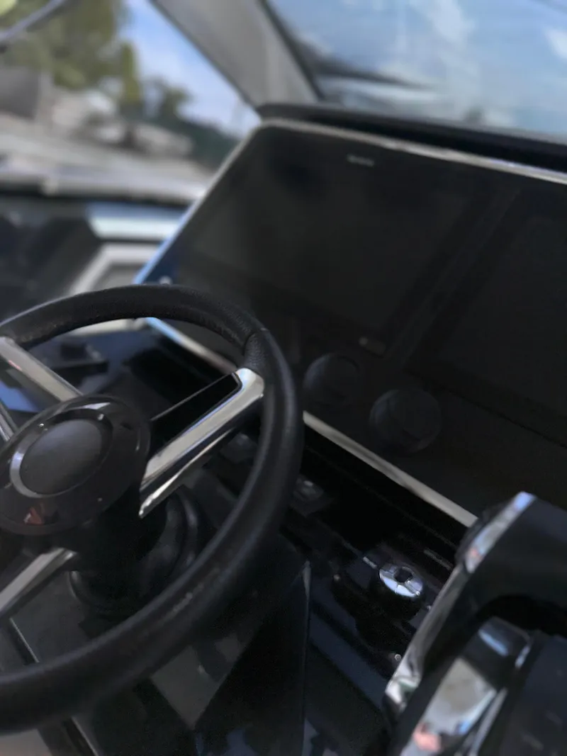 Slide: The Image of 2021 Azimut Verve 47 yacht cockpit with steering wheel and navigation display. - 25