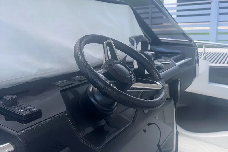 Slide: The Image of Steering wheel of 2021 Azimut Verve 47 yacht, sleek black dashboard design. - 26