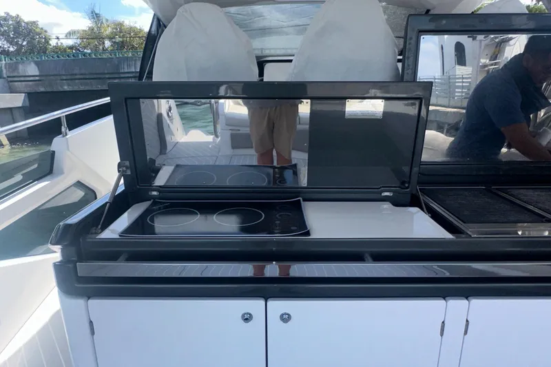 Slide: The Image of 2021 Azimut Verve 47 yacht kitchen area with modern stovetop and sleek design. - 29