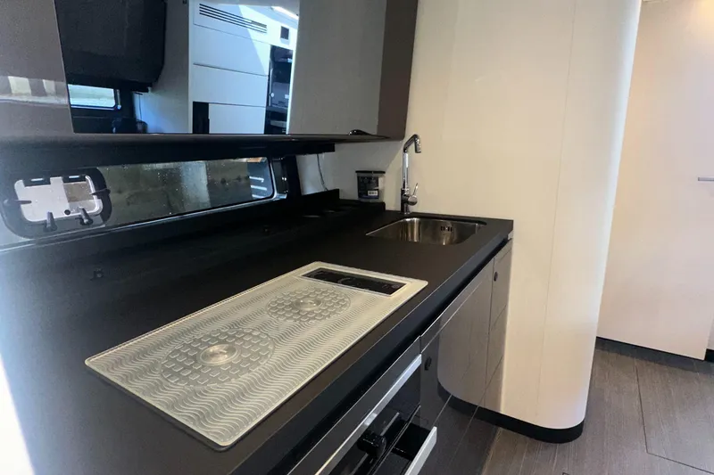 Slide: The Image of 2021 Azimut Verve 47 yacht interior kitchen with sleek countertops and modern sink. - 35