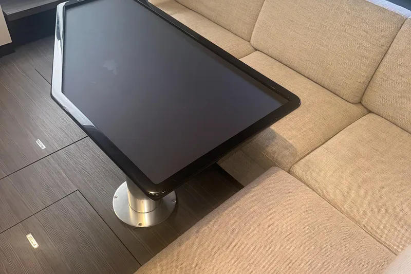 Slide: The Image of Interior of 2021 Azimut Verve 47 yacht with modern table and beige seating. - 36