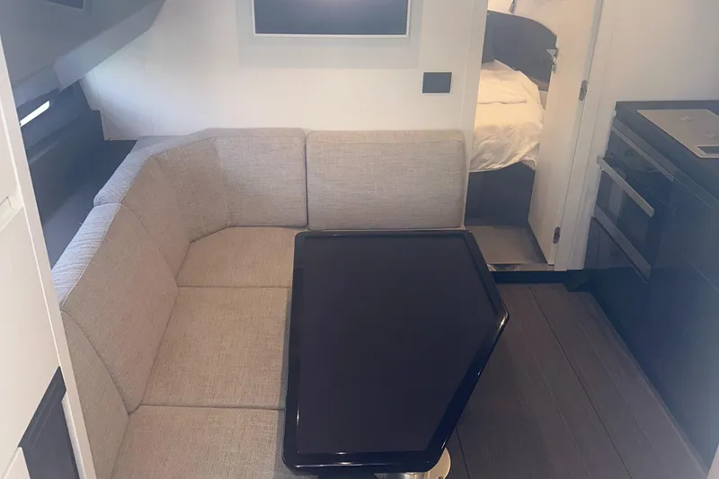 Slide: The Image of 2021 Azimut Verve 47 interior with beige seating and modern table. - 38