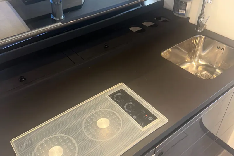 Slide: The Image of Modern kitchen area on 2021 Azimut Verve 47 yacht with sleek sink and cooktop. - 39