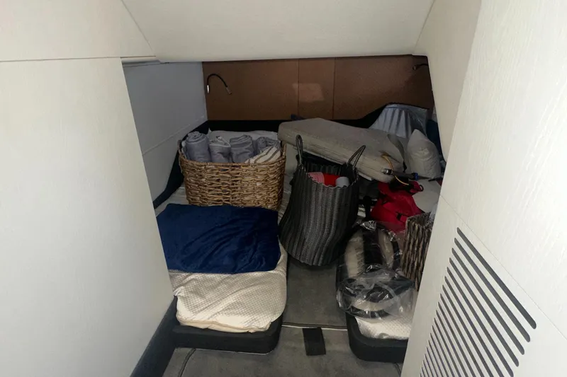 Slide: The Image of 2021 Azimut Verve 47 cabin storage area with baskets and bedding. - 43