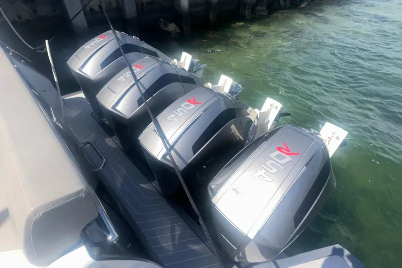 Slide: The Image of Four powerful outboard engines on a 2021 Azimut Verve 47 boat, docked in clear water. - 6