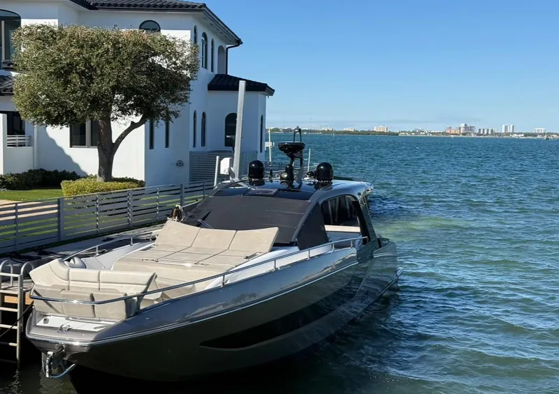 Slide: The Image of Azimut Verve 47 yacht docked by waterfront home, 2021 model. - 8