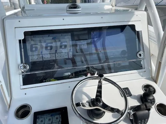 Slide: The Image of 2020 SeaHunter 39 Tournament boat docked on calm water. - 2
