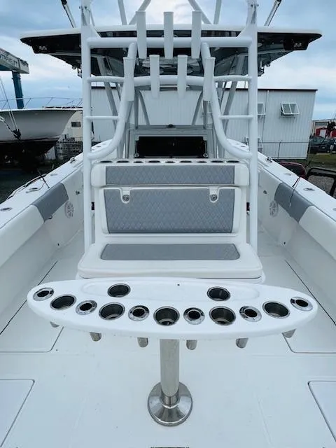 Slide: The Image of 2020 SeaHunter 39 Tournament boat with triple outboard engines, docked near other vessels. - 20