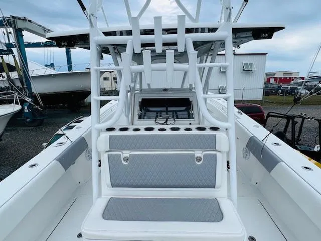 Slide: The Image of 2020 SeaHunter 39 Tournament boat with tower and rod holders, docked under cloudy skies. - 22