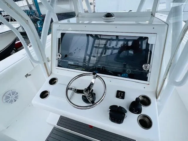 Slide: The Image of 2020 SeaHunter 39 Tournament boat console with steering wheel and controls. - 25
