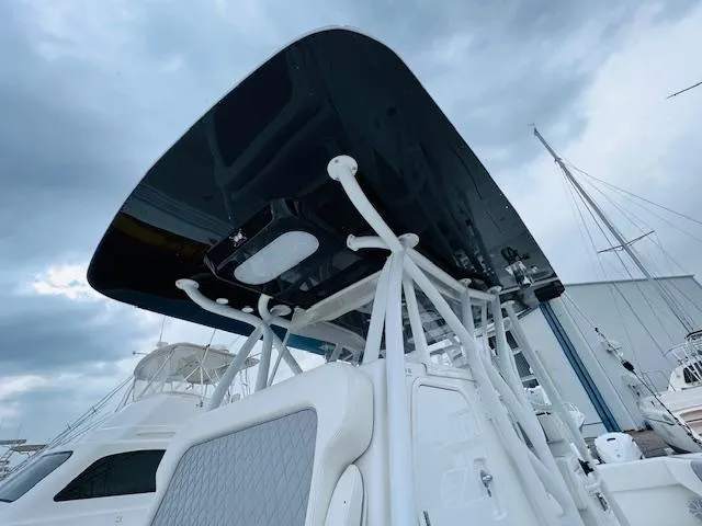 Slide: The Image of 2020 SeaHunter 39 Tournament boat with elevated helm, docked in a marina. - 28