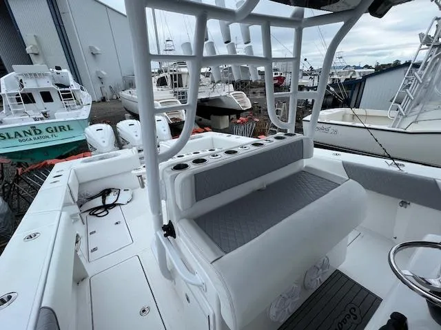 Slide: The Image of 2020 SeaHunter 39 Tournament boat cockpit with steering wheel and controls, docked near other boats. - 30