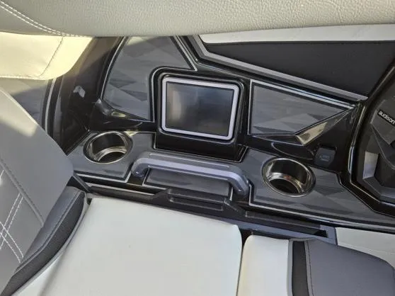 Slide: The Image of 2025 Tigé Ultré 23ZX interior dashboard with touchscreen and cup holders. - 10